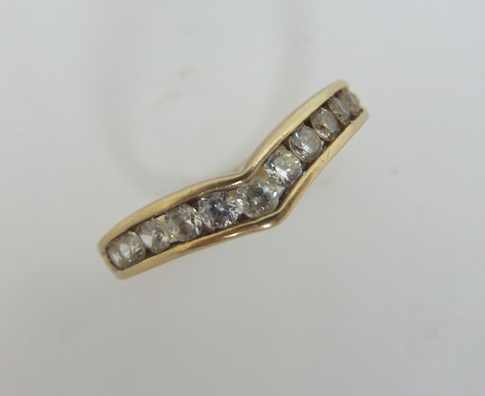 A 9CT GOLD DIAMOND WISHBONE RING, the brilliant cut diamonds within the channel setting, estimated