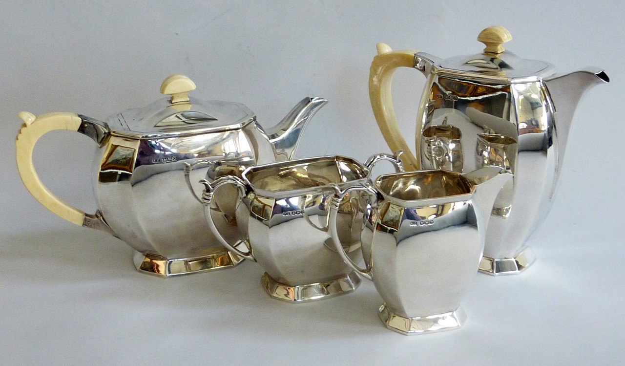 A FRANK COBB & CO ART DECO FOUR PIECE SILVER TEASET, bombe octagonal shapes, ivory handles and