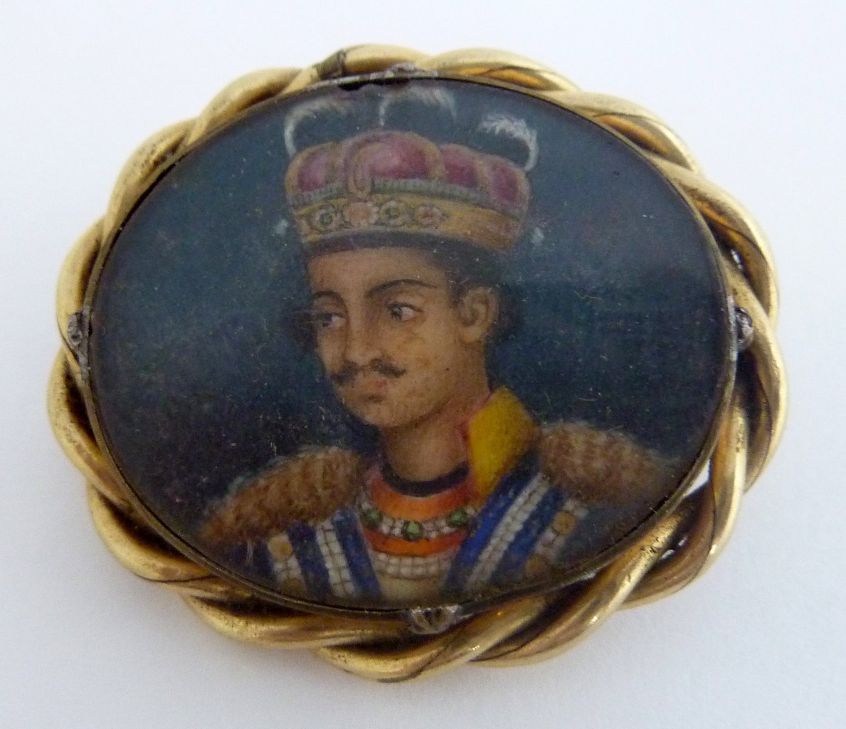 A PINCHBECK OVAL BROOCH, late 19th Century, inset with a miniature portrait of a young Indian Prince