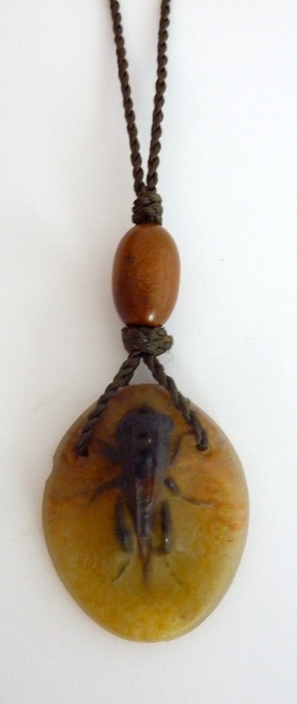 AN ALMERIC WALTER PATE-DE-VERRE NECKLACE, c.1920, as a raised brown grasshopper against a background