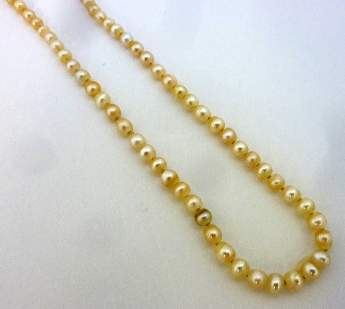 A NATURAL PEARL NECKLACE, designed as a strand of ninty-two pearls with pearl and diamond clasp,