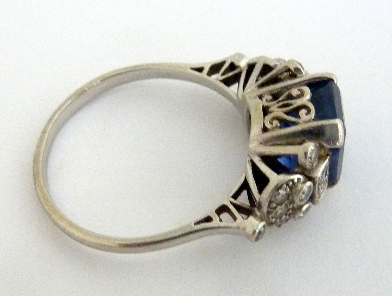 AN ART DECO PLATINUM DIAMOND AND SAPPHIRE RING, the step-cut sapphire to the single-cut diamond - Image 2 of 3