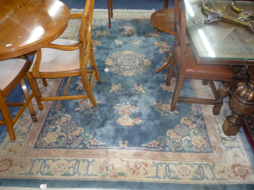 A CHINESE BLUE GROUND CARPET, approximate size 300cm x 200cm and a red ground runner (2)