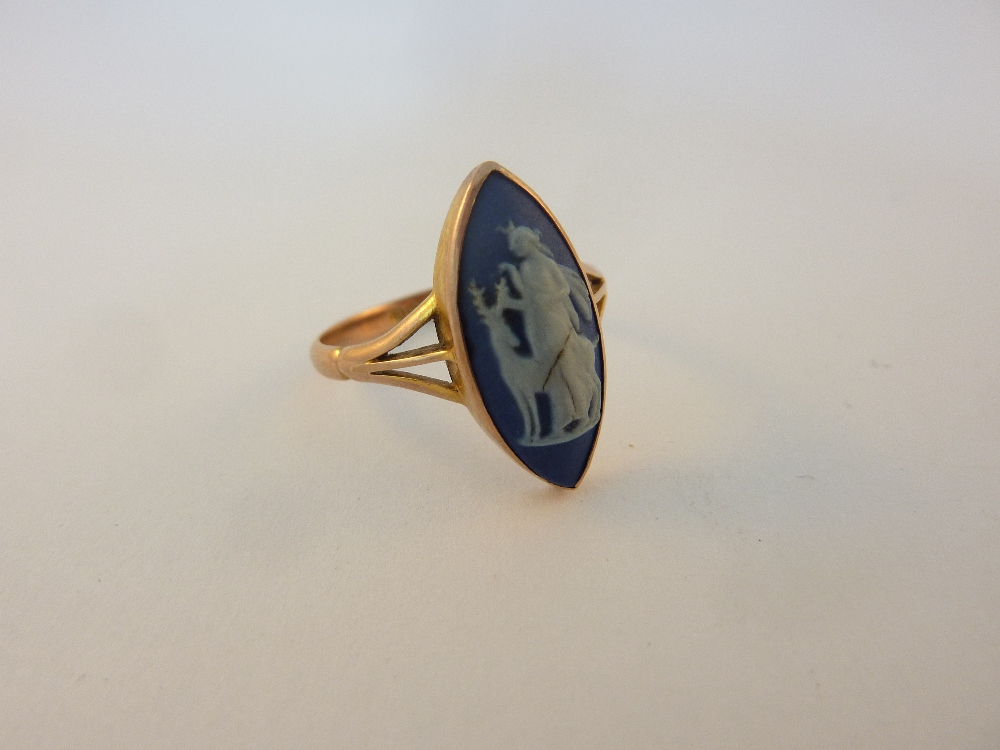 A 9CT GOLD CAMEO RING, the marquise shape Wedgwood cameo depicting the scene of Diana the huntress,