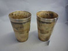 A PAIR OF HORN BEAKERS, white metal mounts dated `1841`, height 10cm (2)