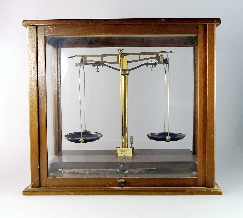 A set of Griffin and George Limited scales, in a glazed case, 46.6cm wide, together with a set of