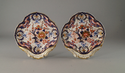 A pair of Imari style Royal Crown Derby plates, 19th century, of shell form with gilt lined