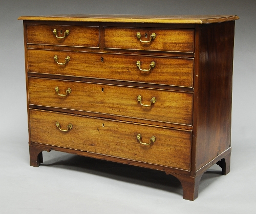 A George III mahogany chest, of two short and three long graduated drawers, upon bracket feet,