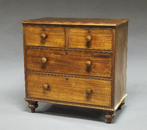 A small Victorian mahogany chest of drawers, with moulded edge over two short and two long graduated