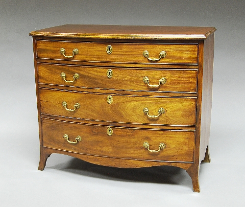 A George III figured mahogany bow front chest, the four graduated drawers with plain loop brass