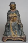 An Oriental painted bronze model of Buddha
Seated in gilt heightened flowing robes.  24. 5 cms high.