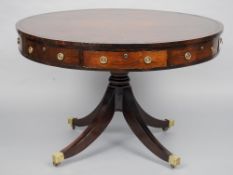 A leather topped rosewood drum table
The tooled red leather inset top above the frieze with