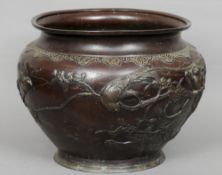 A large late 19th century Japanese bronze jardiniere
Decorated in the round with birds amongst