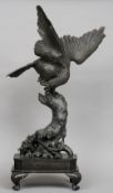 A 19th century Japanese bronze modelled as an eagle
Perched atop a tree stump with a mythical