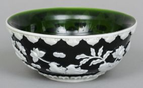 A Chinese Peking glass bowl
Green overlaid with white and carved with ducks amongst water lilies,