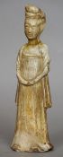 A Chinese celadon ground pottery tomb figure, possibly Ming
The female figure clothed in flowing