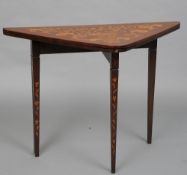A 19th century Dutch marquetry inlaid mahogany card table
The hinged folding triangular top inlaid