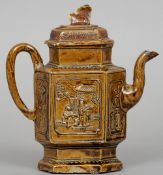 An 18th century Chinese pottery teapot
The mottled brown ground decorated in relief with figures and