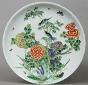 A Chinese porcelain famille verte charger, possibly Kangxi
Decorated with birds and insects
