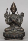 A 19th century Tibetan bronze figure of a hooded priest
Seated in the lotus position.  16.5 cms