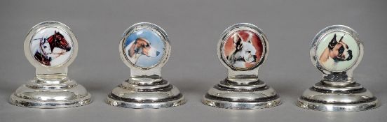 A set of four silver menu holders, each stamped 925
Each of circular form mounted with an enamel