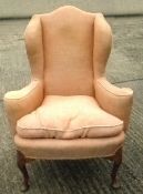 An 18th century style wing back armchair
Of typical form, with shell headed cabriole legs.  91 cms