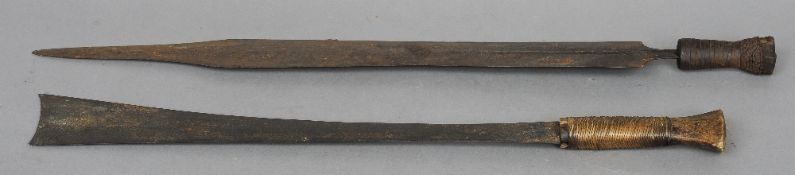 A late 19th/early 20th century African sword
With shaped blade and grass bound grip; together with a