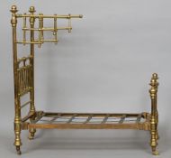 A Victorian miniature brass and cast iron half tester bed
Of typical tubular form, standing on brass