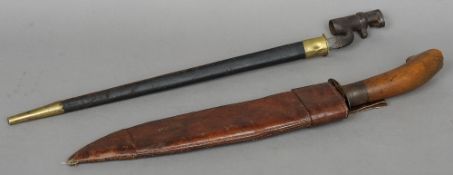 A 19th century bayonet and leather scabbard
With triangular blade and stamped regimental numbers;