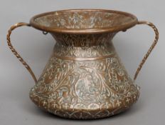 A 19th century Italian twin handled copper vessel
Of waisted cylindrical form with embossed