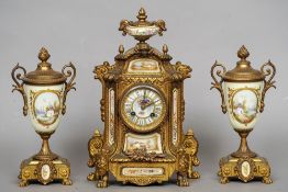 A 19th century Continental porcelain mounted gilt metal clock garniture
The vase shaped finial above