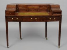 A Victorian mahogany Carlton House desk
Of typical form, the line inlaid arched back with an