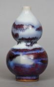 A 19th century Chinese porcelain double gourd vase
With sang de beouf and white ground.  14.5 cms