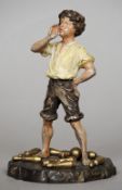 An Austrian cold painted bronze model of a young boy
Standing in short trousers, on a naturalistic