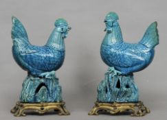 A pair of Chinese turquoise ground pottery models of cockerels, probably Kangxi
Each