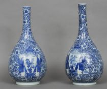 A pair of Chinese blue and white porcelain bottle vases
Each decorated with figures flanking an