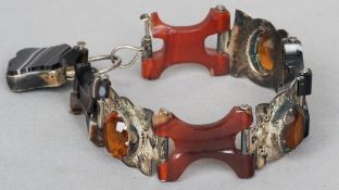 A Scottish unmarked white metal mounted agate and other hardstone set bracelet
Of shaped sectional