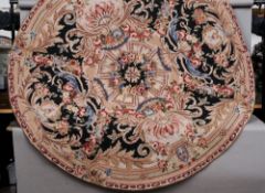 An Aubusson wool rug
Typically worked with floral sprays, circular.  182 cms diameter.   CONDITION