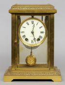A late 19th century brass cased four glass mantel clock
The circular enamel dial with Roman