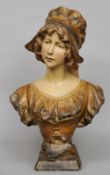 RICHARD AURILI.  A 19th century terracotta bust of a young girl
Modelled wearing a bonnet.  46 cms