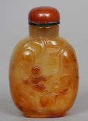 A Chinese carved agate snuff bottle
Worked with a figure.  7 cms high.   CONDITION REPORTS: