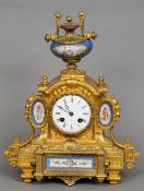 A 19th century Continental porcelain mounted gilt metal mantel clock
The urn form finial above the