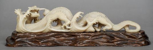 A 19th century Chinese carved ivory model of a dragon
Modelled amongst crashing waves, standing on a