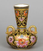 A 19th century twin handled squat vase, possibly Mintons
Decorated with scrolling floral strapwork