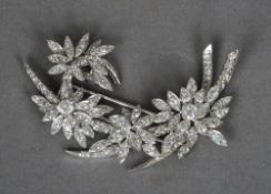 An unmarked white gold or platinum diamond set floral spray brooch
6.5 cms wide.   CONDITION