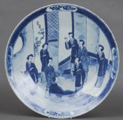A Chinese blue and white porcelain charger
Decorated with female figures in an interior.  37.5 cms