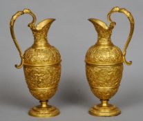 A pair of 19th century Continental gilt bronze decorative ewers
Each with a figurally headed