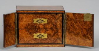 A Victorian burr walnut humidor
The twin door cabinet with two interior drawers with brass