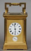 A 19th century French gilt brass cased carriage alarm clock
The main white enamel dial with Roman
