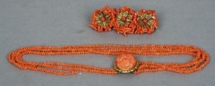 A Victorian multi-strand coral necklace
Centred with a yellow metal mounted carved coral figural